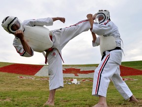 Paul Jackman (left) throws a high kick at Rob Yeoman during an outdoor Koshiki Superkaratedo training session. The longtime martial artists are also organizers of the World Koshiki Superkaratedo Championships coming to London July 29 and 30. (CHRIS MONTANINI, Londoner)