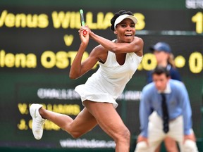 Venus Williams returns against Jelena Ostapenko during their women's singles quarter-final match on the eighth day of the 2017 Wimbledon Championships at The All England Lawn Tennis Club on July 11, 2017. (AFP)