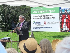 Bishop Michael Oulton of the Anglican Diocese of Ontario speaks to a crowd comprised of the local community and church congregation, Habitat for Humanity Volunteers and employees, Mayor Bryan Paterson and the new homeowner families benefiting from the Good Shepherd Legacy Affordable Housing Project at 46 Cowdy St. on Tuesday. (Ashley Rhamey/For The Whig-Standard)