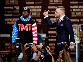 Floyd Mayweather Jr. (left) and Conor McGregor face off on stage during the World Press Tour at Staples Center on July 11, 2017 in Los Angeles. (Harry How/Getty Images)