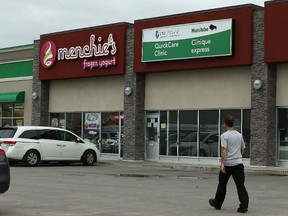 A man walks past a QuickCare Clinic in a strip mall on Dakota Street in Winnipeg on Tues., July 11, 2017. The clinic is one of four slated to shut down in January 2018, the Winnipeg regional Health Authority announced. Kevin King/Winnipeg Sun/Postmedia Network