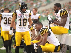 Hamilton Tiger-Cats defensive back Justin Rogers, seated, takes a breather during CFL action against the Saskatchewan Roughriders in Regina on July 8, 2017. (THE CANADIAN PRESS/Mark Taylor)