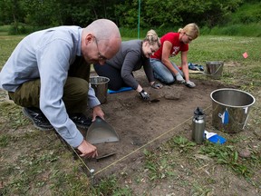 Left to right: Volunteer Thomas Borreson, and anthropology field students from MacEwan University Tara Turnbull and Lace Walters survey and excavate the site of the former Vogel's Meatpacking plant, in Edmonton's Mill Creek ravine Tuesday July 11, 2017.