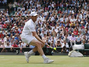 Sam Querrey of the United States returns to Britain's Andy Murray during their Men's Singles Quarterfinal Match on day nine at the Wimbledon Tennis Championships in London Wednesday, July 12, 2017. (AP Photo/Tim Ireland)