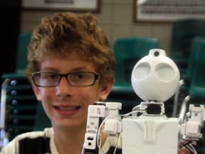 William McDowell holds a robot during the robotics course at the NGPS summer boot camp classes on July 6 (Joseph Quigley | Whitecourt Star).