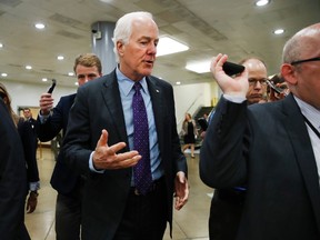In this July 11, 2017, photo, Senate Majority Whip John Cornyn of Texas, center, speaks to reporters on Capitol Hill in Washington. Emails released by President Donald Trump’s eldest son Tuesday detailing communications with Russians provoked a collective shrug from many Republicans in Congress. (AP Photo/Jacquelyn Martin)