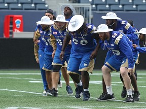 The offensive line sports safari hats during the Winnipeg Blue Bombers walkthrough at Investors Group Field in Winnipeg on Wed., July 12, 2017, ahead of its CFL game Thursday against the Toronto Argonauts. Kevin King/Winnipeg Sun/Postmedia Network