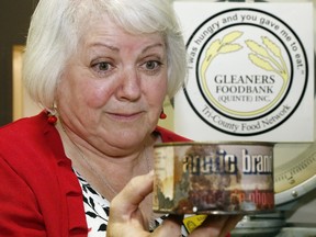 Luke Hendry/The Intelligencer 
Susanne Quinlan of Gleaners Food Bank holds a can of decades-old seal meat at the warehouse in Belleville Wednesday. The can arrived amid donations during the 2016 holiday season. Donations of expired food costs the food bank time in handling and disposal and Quinlan asks all donors to check items' dates before contributing.