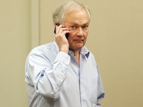 Donald Fehr, Executive Director of the NHLPA, chats on the phone at the Westin Times Square Hotel on Dec. 4, 2012 in New York City. (Bruce Bennett/Getty Images)