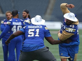 OL Jermarcus Hardrick (left) covers fellow OL Sukh Chungh on a pass route ahead of the Winnipeg Blue Bombers walkthrough at Investors Group Field in Winnipeg on Wed., July 12, 2017, ahead of its CFL game Thursday against the Toronto Argonauts. Kevin King/Winnipeg Sun/Postmedia Network
