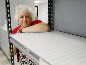 Luke Hendry/The Intelligencer
Operations director Susanne Quinlan stands next to empty shelves at Gleaners Food Bank in Belleville Wednesday. There is much food in the warehouse, she said, but donations of staple foods are needed.