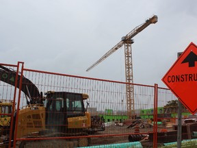 A man, 29, was charged with mischief for climbing a 45-metre crane at a St. Thomas construction site on Tuesday. Police contacted the man on his cellphone and convinced him to come down and then arrested him. (DALE CARRUTHERS, The London Free Press)