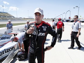 Will Power, of Australia, talks with crew members after winning the pole position for the IndyCar Series auto race on July 8, 2017, at Iowa Speedway in Newton, Iowa. (AP Photo/Charlie Neibergall)