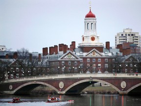 In this March 7, 2017 file photo, rowers paddle along the Charles River past the Harvard College campus in Cambridge, Mass. (AP Photo/Charles Krupa, File)