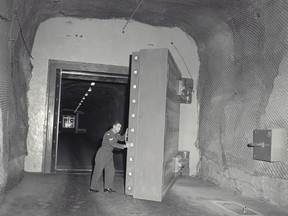 A member of the Canadian Forces opens with ease one of the three perfectly balanced 17.25-tonne blast doors protecting the underground complex that houses the co-located headquarters of Northern NORAD Region and NORAD in North Bay, Ont. is seen in this undated handout photo. It's a plan that gives a whole new meaning to buried treasure. A national foundation wants to store millions of videos, films and other recordings 60 storeys underground in an old NORAD bunker near North Bay, Ont., an effort to preserve the vast electronic record of Canadian history. THE (CANADIAN PRESS/HO, Royal Canadian Air Force)