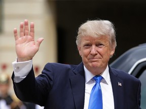 U.S. President Donald Trump waves as he arrives for a meeting with French President Emmanuel Macron at the Elysee Palace in Paris, Thursday, July 13, 2017. Trump will be the parade's guest of honor to commemorate the 100th anniversary of the U.S. entry into World War I. U.S. troops will open the parade Friday as is traditional for the guest of honor. (AP Photo/Markus Schreiber)