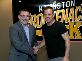 Jay Varady, left, shakes hands with Doug Gilmour, Kingston Frontenacs president of hockey operations, after Varady was introduced as the new head coach of the Ontario Hockey League team at a new conference at the Rogers K-Rock Centre on Thursday. (Ian MacAlpine/The Whig-Standard)