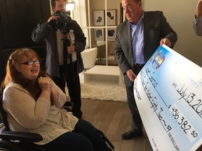 Dream Lottery 50/50 draw winner Elizabeth Garcia, left, is blown away with her $456,382.50 cheque presented by Children's Health Foundation president Scott Fortnum Thursday morning at the London dream home. St. Thomas resident Dermot Brennan won the grand prize -- his choice of the north London dream home, a Port Stanley beachfront condo or $1 million cash. (JENNIFER BIEMAN, The London Free Press)
