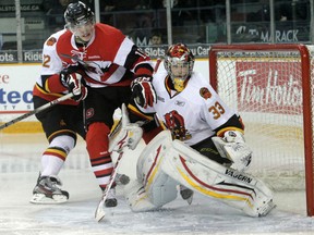 Ottawa 67's Tyler Graovac (19) puts a hand on Bulls goalie John Chartrand (33) as he gets pushed into the crease area by Brady Austin (22) during OHL action in Ottawa on Friday, January 6, 2012. Mike Carroccetto/Postmedia News