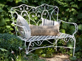 Instead of investing in new metal furniture, refinish what you have for the cost of a can of paint and a brush. This ivy metal bench was painted with a mixture of Original and Graphite and features a striped cushion using Paris Noir fabric by Annie Sloan.?(Photo: Christopher Drake/Annie Sloan)