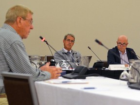 Cove Country Inn owner Terry Cowan, left, gives his opening statement at the Standing Committee on Finance and Economic Affairs hearing in Kingston Thursday. Liberal MPPs Grant Crack, centre, and Peter Milczyn listen. (Joseph Cattana/For The Whig-Standard)