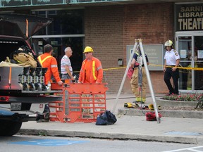 Firefighters, Bluewater Power staff and library workers assess  damage from a late afternoon transformer fire in the basement of the Sarnia Public Library. Library staff safely evacuated everyone from the building. (NEIL BOWEN/Sarnia Observer)
