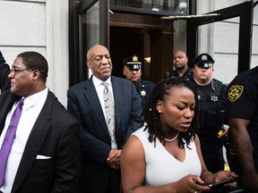 Bill Cosby listens to his wife Camille's statement being read aloud by Ebonee M. Benson outside the Montgomery County Courthouse after a mistrial in his sexual assault case in Norristown, Pa., Saturday, June 17, 2017. (AP Photo/Matt Rourke)