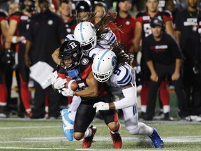 Ottawa Redblacks wide receiver Diontae Spencer is tackled by Toronto Argonauts linebacker Marcus Ball and defensive back Akwasi Owusu-Ansah during CFL action in Ottawa on July 8, 2017. (THE CANADIAN PRESS/Patrick Doyle)