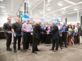 Millennium1 Solutions chairman Don Moffatt and Greater Sudbury Mayor Brian Bigger, along with CEO Tom Band and employees and dignitaries, cut the ribbon at the official grand opening of the Millennium1 Solutions call centre on Thursday. The new business will eventually employ 250 people. (Gino Donato/Sudbury Star)