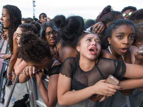 Young women react to the crushing crowd as they wait for Migos at RBC Bluesfest on Thursday, July 13, 2017. WAYNE CUDDINGTON/ POSTMEDIA
