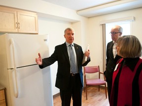 File photo - Laurie Hawn and Stephen Mandel get a tour of the Edward Street assisted living building in Edmonton on Jan. 23, 2012, from Linda Padgham.