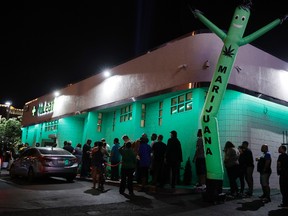 In this Saturday, July 1, 2017, file photo, people line up at the NuLeaf marijuana dispensary in Las Vegas. (AP Photo/John Locher, File)
