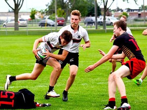 A Belleville U18 boys Junior Bulldogs ballcarrier prepares to go into contact against a Bristol Cathedral Choir School defender during an international rugby match Thursday night at MAS Park Field 4. (Chip McIntosh for The Intelligencer)