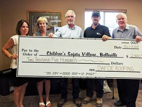 From left: Julie Bennett, executive director of the Children's Safety Village; Jean Czyczyro, vice-chair of the CSV; Dayle Dafoe and Matt Dafoe of Dafoe Roofing; and Richard Hanson, chair of the CSV. (Submitted photo)
