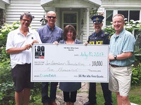 Colleen MacAllister from San Damiano Foundation accepts a $10,000 cheque from 100+ Men Who Care Quinte members (from left) Ken Manderville, Gary Buffett, James Locke and Ian Press. (Submitted photo)