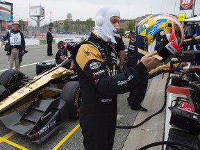 James Hinchcliffe puts his helmet on before hitting the track for his first practice session for the Toronto Indy on Friday July 14, 2017. (THE CANADIAN PRESS/Frank Gunn)