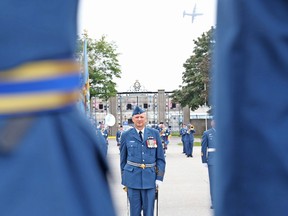 Jason Miller/The Intelligencer 
A Royal Canadian Air Force  aircraft flies overhead, while incoming Wing Commander  Col. Mark Goulden takes charge of CFB Trenton.