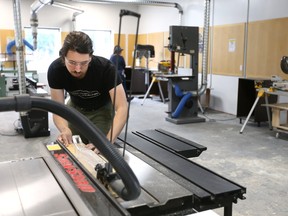Devon Curtis, 30, rips a piece of wood on a table saw at the London Community Woodshop at 195 Horton St. The woodworking shop intends to become a community hub for people learning new skills. Operated by Pathways Skill Development, the shop offers monthly or yearly memberships for hobbyists. (MIKE HENSEN, The London Free Press)