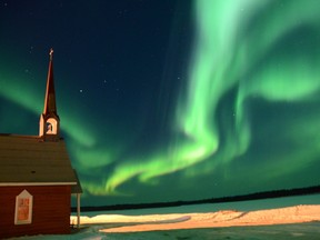 A photo by Kevin Kuipers titled 'Northern Lights shining over the Peace River and St. Jean-Baptiste Church in Garden River.' Photo supplied/Kevin Kuipers