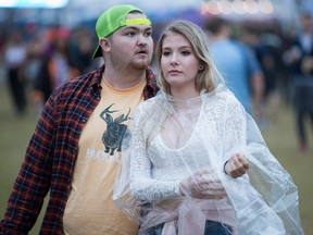 Sydney Bell, 16, came dressed for the rain while her friend Jeff Stanton, 18, took his chances on Friday night as RBC Bluesfest takes place on the grounds of the Canadian War Museum.