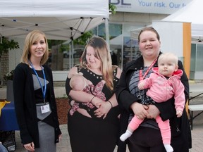Porcupine Health Unit Public Health Nurse Meagan Potvin, left, and Models Laurissa and Winter Crocetti stand beside one of the 'Breastfeeding in Public' models at the Urban Park in Timmins in this July 12, 2017, handout image. Porcupine Health Unit image