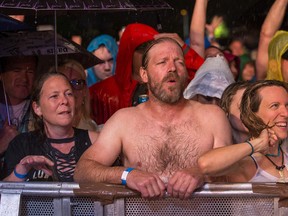 With the rain pouring down, a fan went shirtless during LiVE's short performance. Photo Wayne Cuddington/ Postmedia