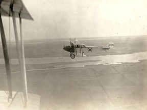 Deseronto Archives Photo
Aerial photograph of Curtiss JN-4 aircraft number C126, taken over open fields with some stretches of water from another aircraft, whose wing is visible. The aircraft were from Camp Mohawk, one of the World War I Royal Flying Corps pilot training camps near Deseronto, Ontario.