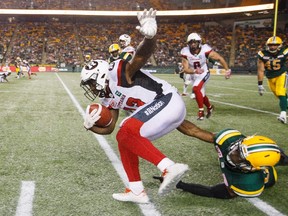 Ottawa Redblacks' Brett Maher (13) is taken down by Edmonton Eskimos' Kenny Ladler (37) during second half CFL action in Edmonton, Alta., on Friday July 14, 2017. (THE CANADIAN PRESS/Jason Franson)