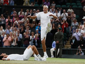 Poland's Lukasz Kubot, right, and Brazil's Marcelo Melo who lies on the floor celebrate after defeating Austria's Oliver Marach, and Croatia's Mate Pavic in the Men's Doubles final match on day twelve at the Wimbledon Tennis Championships in London, Saturday, July 15, 2017. (AP Photo/Kirsty Wigglesworth)