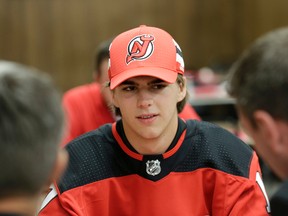 New Jersey Devils' Nico Hischier talk with fans and patrons at Hobby's Deli in Newark, N.J., Monday, June 26, 2017. The 18-year-old center was the first Swiss-born player to be drafted first overall in a NHL draft. (AP Photo/Seth Wenig)