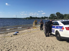 Ottawa police are at the scene after a man was found unresponsive in the water at Britannia Beach on Saturday.