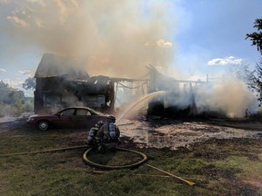 Ottawa firefighters at the scene of a Bank Street barn fire on Saturday.