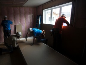 Volunteers work on a Habitat for Humanity site near 22 Avenue and 24 Street, in Edmonton Monday July 10, 2017. Seventy-five homes in Edmonton and Fort Saskatchewan will be built during this year's Jimmy and Rosalyn Carter Work Project. Photo by David Bloom