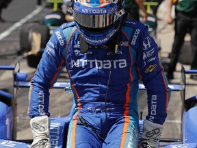Scott Dixon, of New Zealand, climbs out of his car following during a practice for the Indianapolis 500 IndyCar auto race at Indianapolis Motor Speedway, Monday, May 22, 2017, in Indianapolis. (AP Photo/Darron Cummings)
